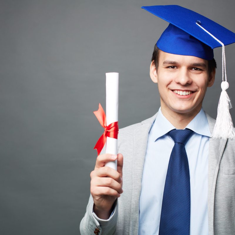 Student with diploma Portrait of confident student with graduation certificate looking at camera